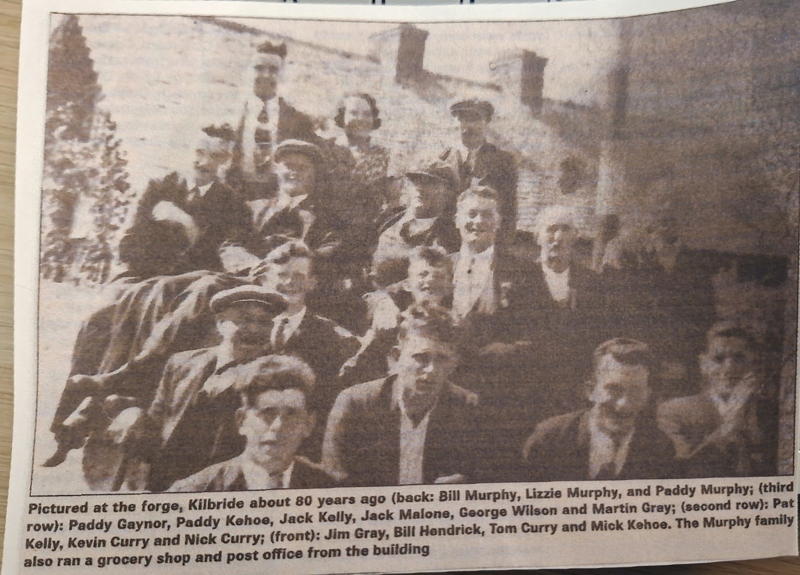An undated newspaper clipping showing the Murphy family and neighbours gathered at the forge in Kilbride